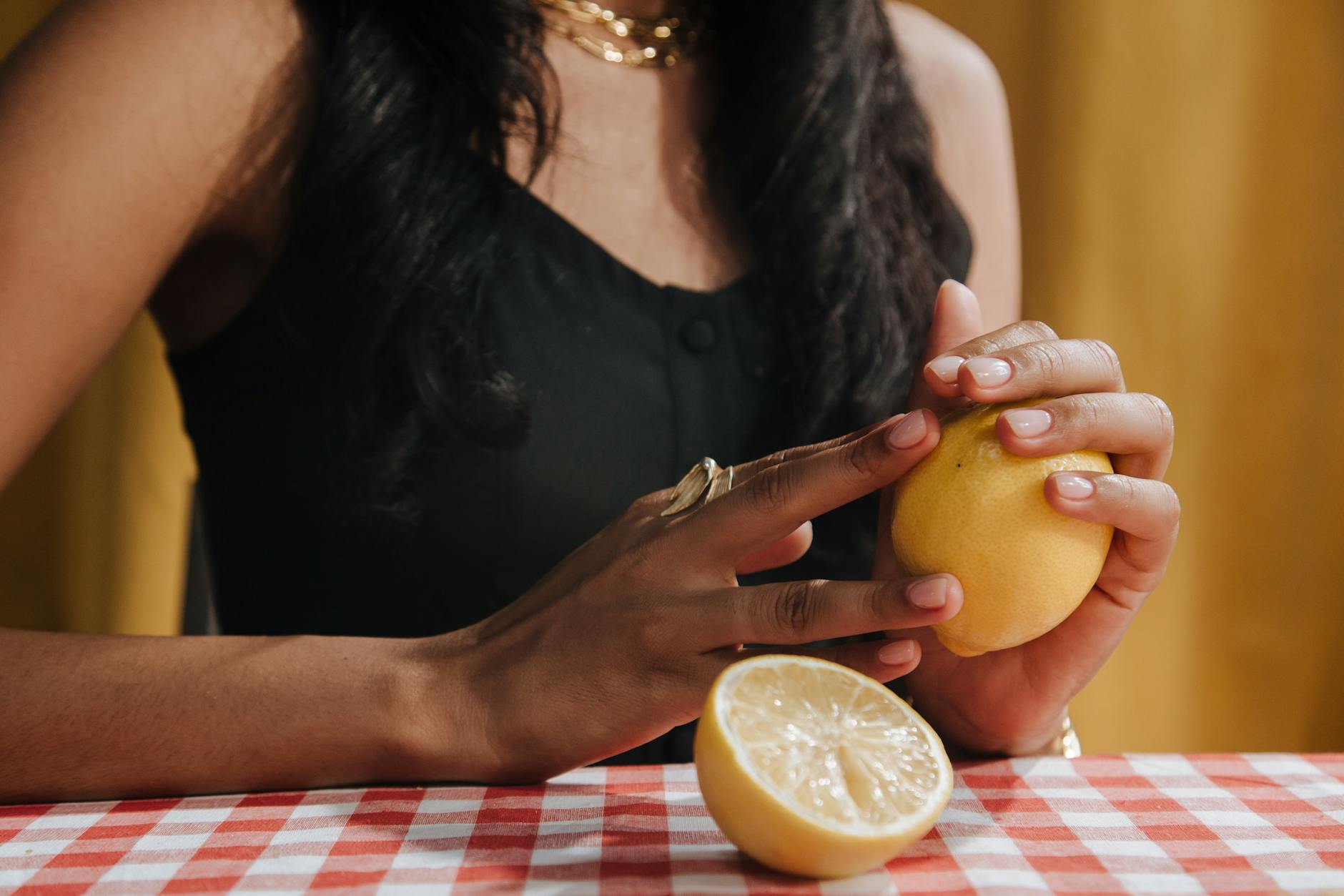 Woman holding blue and pink silicone vibrators in contemplation
