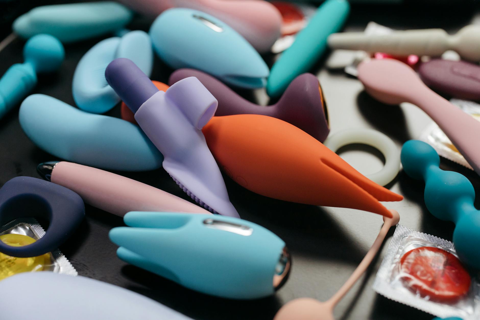 A teal lemon vibrator resting on smooth white silk, inviting and approachable for anyone returning to pleasure
