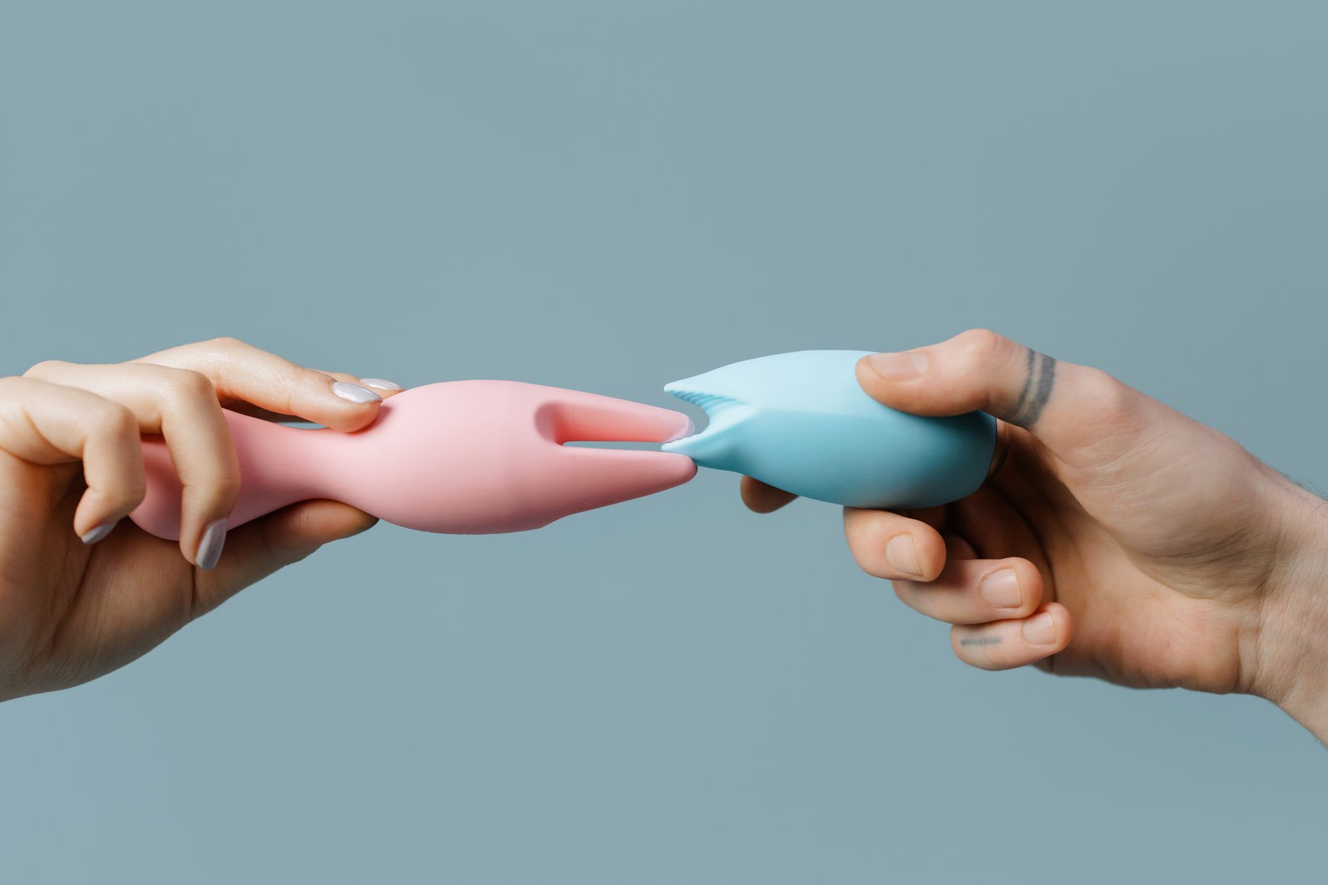 Hands holding colorful silicone toys, symbolizing choice and safe exploration.
