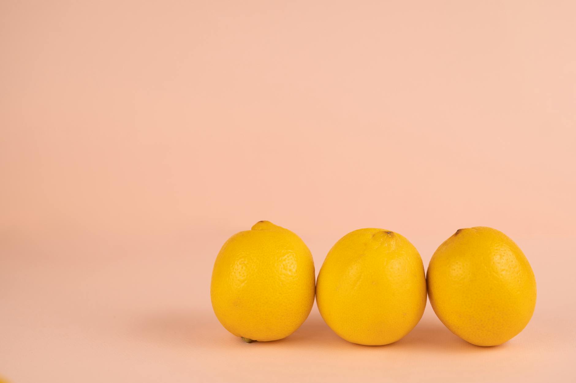 Bright ripe lemons on a pastel background, symbolizing fresh approaches to intimacy.